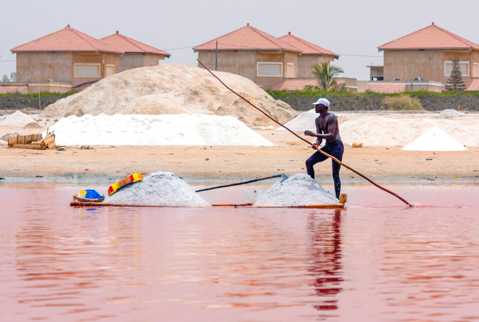 man in black jacket and blue pants riding on blue kayak on body of water during
